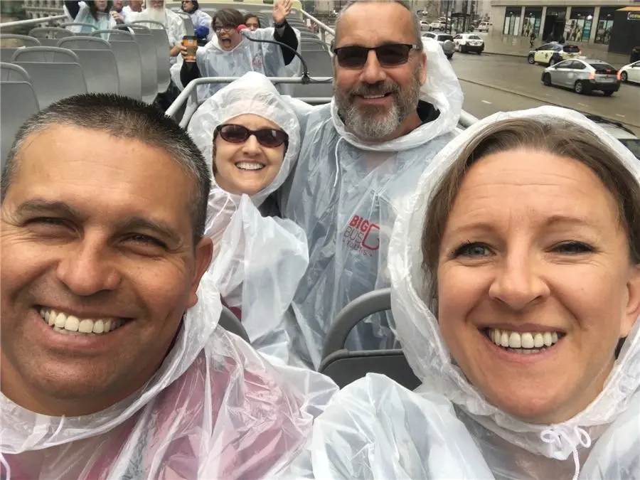 Group selfie in rain ponchos on a tour