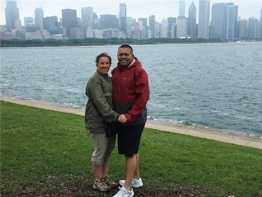Couple by the water with the Chicago skyline behind