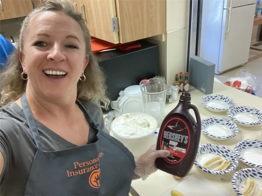 CarrieAnne in a Personal Touch apron serving breakfast